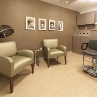 A modern salon waiting area with comfortable seating and stylish decor.