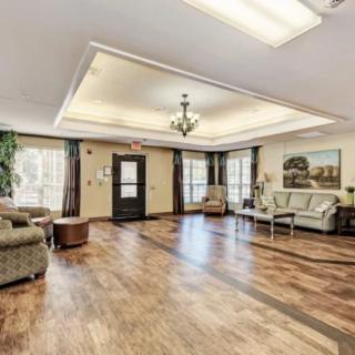 A spacious and well-lit lobby with comfortable seating and wooden floors.