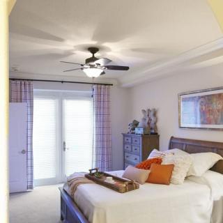 A modern bedroom with elegant decor and a cozy atmosphere.