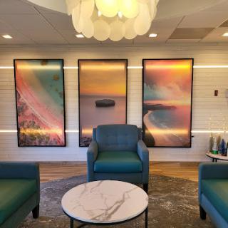 A stylish lounge area featuring modern furniture and vibrant abstract artwork.
