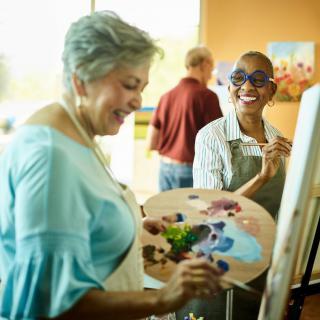 A group of people enjoying a painting class together, expressing creativity and having fun.