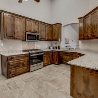 A modern kitchen with wooden cabinets and stainless steel appliances.