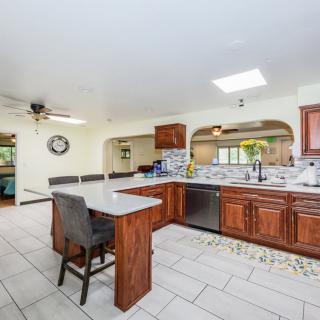 Spacious kitchen with wooden cabinets, a central island, and modern appliances.