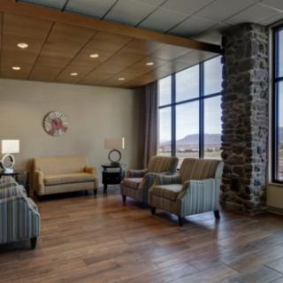 A spacious and well-lit lobby with comfortable seating and large windows offering scenic views.