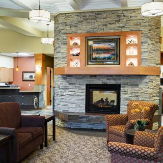 A cozy and modern living room with a central fireplace and comfortable seating.