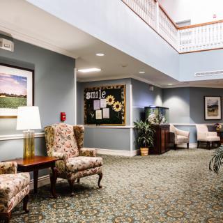 A cozy lobby with elegant seating, artwork, and soft lighting.