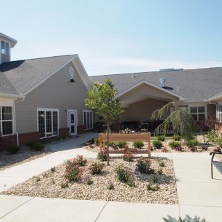 A well-maintained courtyard with landscaping and a modern building in the background.