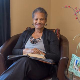 A woman enjoying a moment of relaxation while reading in a cozy indoor setting.