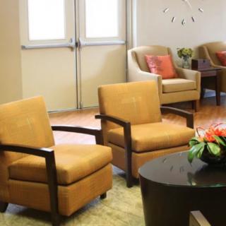 A cozy waiting room with comfortable seating and a stylish coffee table.