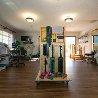 A well-equipped physical therapy room featuring various exercise tools and machines.