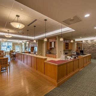A modern restaurant interior with wooden furnishings and ambient lighting.