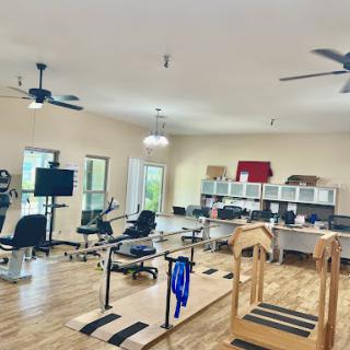 A spacious and well-equipped therapy room designed for rehabilitation and exercise.