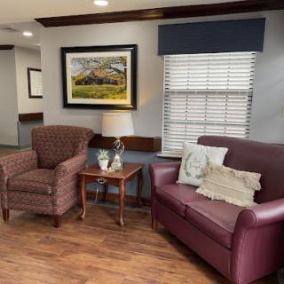A cozy living room setting with comfortable seating and decorative artwork.