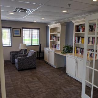 Cozy library corner with bookshelves and seating area.
