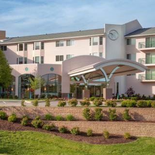 Modern hotel building with landscaped entrance area.