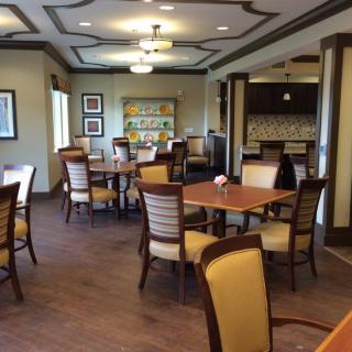 An elegantly furnished dining area with several tables and chairs arranged neatly.
