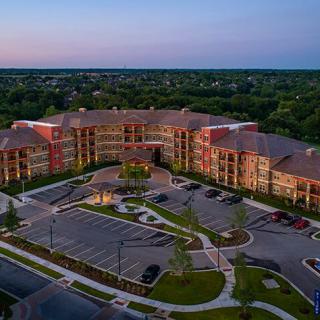 Aerial view of a large residential building complex at sunset.