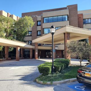 A modern building with a welcoming entrance and landscaped surroundings.