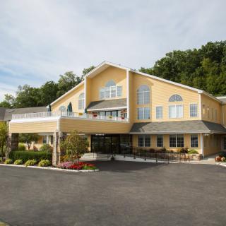 A hotel building with a welcoming entrance and landscaped surroundings.