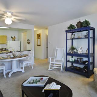 A cozy living space with a dining area, kitchen, and tasteful furnishings.