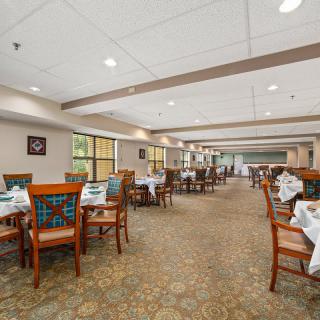 A spacious and elegantly designed restaurant dining area with neatly arranged tables and chairs.