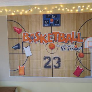 A vibrant basketball-themed decoration featuring jerseys, a court design, and playful elements perfect for sports enthusiasts.