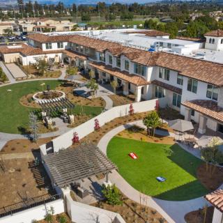 Aerial view of a well-planned residential housing complex with landscaped courtyards and green spaces.