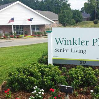 Winkler Place Senior Living facility with surrounding greenery and signage.