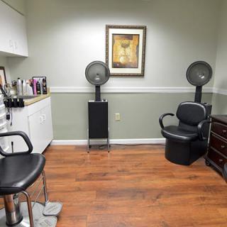 A well-organized hair salon with chairs, a hair drying station, and stylish decor.