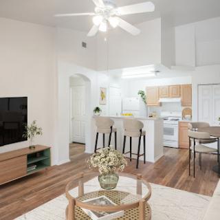 A stylish open-concept living area featuring a modern kitchen and cozy seating arrangement.