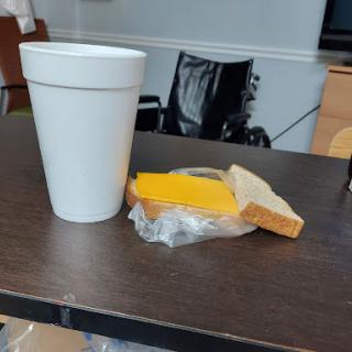 A simple snack of cheese on bread accompanied by a drink.
