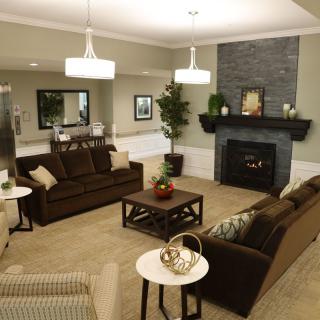 A cozy living room with comfortable seating and a modern fireplace.