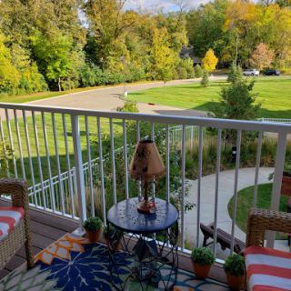 A cozy balcony view overlooking a lush landscape, perfect for relaxation.