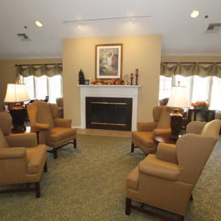 A cozy living room with a fireplace and arranged seating area.