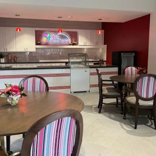 A cozy cafe with colorful striped chairs and tables ready for guests.