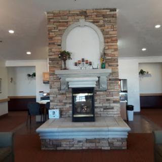 A cozy lobby featuring a decorative stone fireplace.
