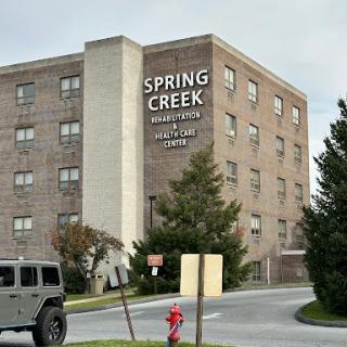 A view of the Spring Creek apartment building, featuring its prominent signage.