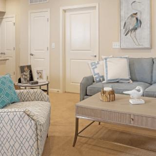 A cozy and elegantly decorated living room featuring comfortable seating and tasteful decor.