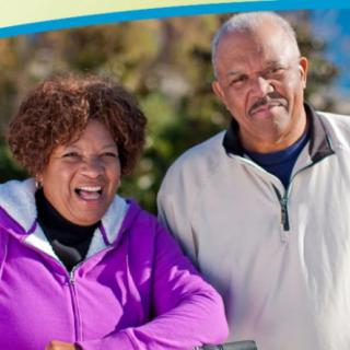 An elderly couple enjoying a day outdoors, smiling and content.