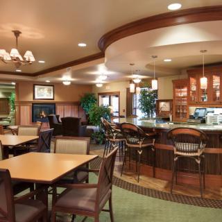 A cozy restaurant interior with a bar area and dining tables.