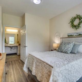A cozy and minimalist bedroom with warm lighting and tasteful decor.