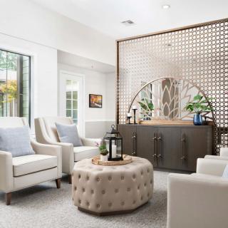 A modern living room with cozy chairs and a stylish partition wall.