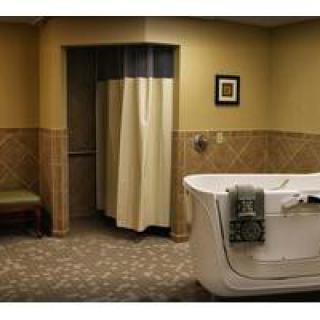 A bathroom featuring a bathtub and shower area with a curtain.