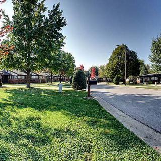 A peaceful suburban street lined with trees and houses.