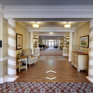 A well-lit hotel lobby with elegant decor and furniture.
