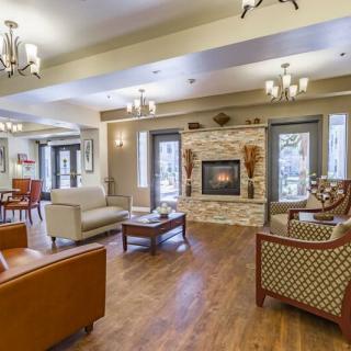 A cozy living room with elegant furniture and a warm fireplace.