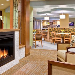 A cozy lounge area with a fireplace and modern seating arrangement.