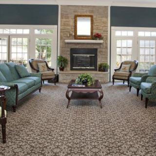 A spacious living room with elegant furniture and a cozy fireplace.