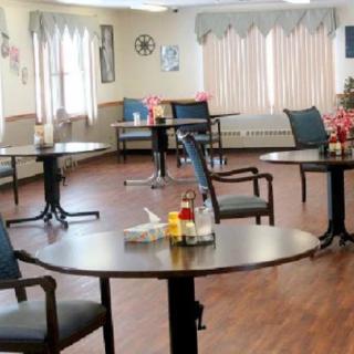An empty dining area with neatly arranged tables and chairs.