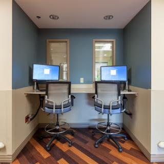 A small office space featuring two computer workstations with modern chairs.